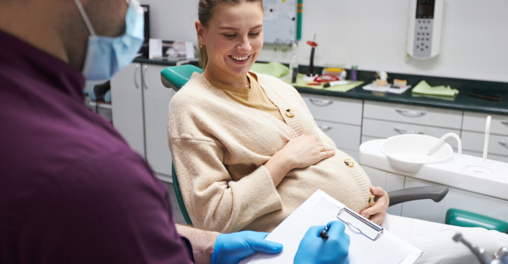 Dentist prescribing a treatment to a pregnant woman