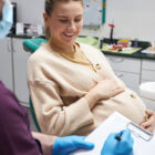 Dentist prescribing a treatment to a pregnant woman